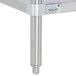 A stainless steel wood top work table with a metal undershelf and metal legs.