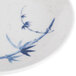 A close-up of a blue Thunder Group Blue Bamboo sauce dish on a table.
