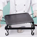 A person using an American Metalcraft wrought iron griddle on a table.