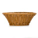 A honey brown round polyweave bread basket with a handle.