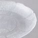 A clear plastic plate with a flower design.