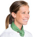A woman wearing a white chef coat and a seafoam green Intedge chef neckerchief.