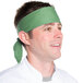 A man wearing a seafoam green chef neckerchief.