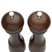 A close-up of a Chef Specialties Windsor Walnut pepper mill with a silver knob.