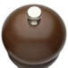 A close up of a Chef Specialties Windsor walnut pepper mill with a silver metal cap.