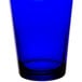 A blue glass tumbler with a clear rim.