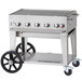 A Crown Verity liquid propane outdoor BBQ grill on a cart with wheels.
