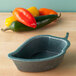 A black Polyethylene bowl with jalapeno peppers on it.