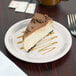 A slice of cheesecake on a Carlisle Sierrus melamine pie plate.