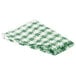 A folded green and white checkered vinyl table cover.