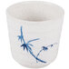 A white melamine cup with blue bamboo design on the outside.
