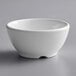 A Thunder Group white melamine soup bowl on a gray surface.