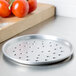 An American Metalcraft round metal pizza pan with holes in it.