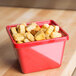 A red GET square melamine crock filled with croutons.