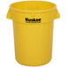 A yellow plastic Continental round trash can with black Huskee logo.