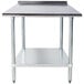 A white rectangular Advance Tabco stainless steel work table with a backsplash and undershelf.