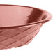 A red polyethylene oval weave basket with a brown pattern.