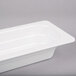 A white rectangular GET Melamine food pan.