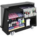 A black Cambro portable bar cart with bottles of alcohol and drinks.