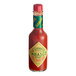 A close up of a TABASCO Cayenne Garlic Pepper Hot Sauce bottle.