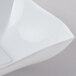 A close up of a white Fineline Wavetrends plastic serving bowl with a curved edge.