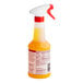 A Vegalene spray bottle with white and orange liquid and a red and white sprayer.