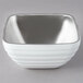 A Vollrath stainless steel square bowl with a silver rim.