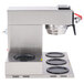 A silver Bunn automatic coffee brewer with a stainless steel funnel over five burners.