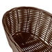 A brown oblong rattan basket with a handle.