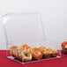 A Cal-Mil clear acrylic bin filled with bagels and muffins.