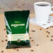 A green bag of Ellis Mezzaroma Royal Sumatra Decaf Coffee next to a cup of coffee.