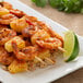 A plate of food with shrimp and rice seasoned with Regal Caribbean Sunrise Jerk Seasoning.