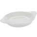 A white round shirred egg dish with a handle.