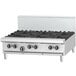A stainless steel Garland countertop gas range with a griddle over black knobs.