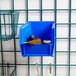 A blue plastic Metro stack bin with metal hooks on it.