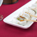 A CAC Long Island white porcelain platter with sushi rolls and chopsticks on it.
