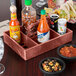 A HS Inc. paprika condiment organizer on a table with a variety of condiments and food.