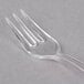 A clear plastic Fineline Tiny Tines tasting fork.