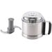 A stainless steel Robot Coupe cutter bowl with a lid and a blade.