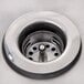 A stainless steel sink drain with a drain hole.