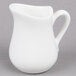 An American Metalcraft white porcelain bell creamer with a handle on a gray surface.