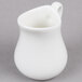 An American Metalcraft white porcelain bell creamer with a handle.