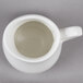 An American Metalcraft porcelain bell creamer with a handle.