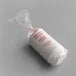 A clear plastic bag containing white fluted baking cups with red text on the label.