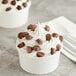 A cup of ice cream with Mini Milk Chocolate Peanut Butter Cups on top.