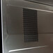 The stainless steel door of a Panasonic commercial microwave.