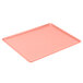 A blush pink Cambro dietary tray with a small hole in the middle.