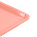 A close up of a pink Cambro dietary tray with a handle.