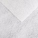 A close-up of a white fabric with a pattern.