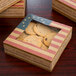 An 8" x 8" x 2" bakery box with an American flag design holding cookies.